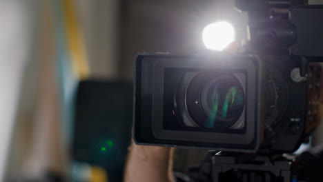 Close-Up-Of-Male-Film-Camera-Operator-Focusing-Lens-On-Camera-Shooting-Movie-Or-Video-In-Studio-1